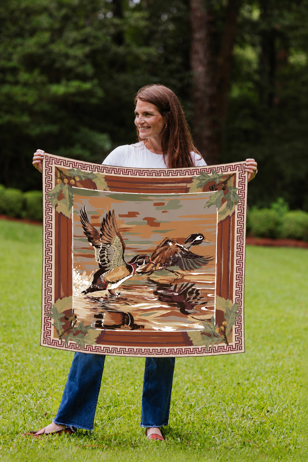 Model holding the Cognac Dusk Landing wood duck silk scarf