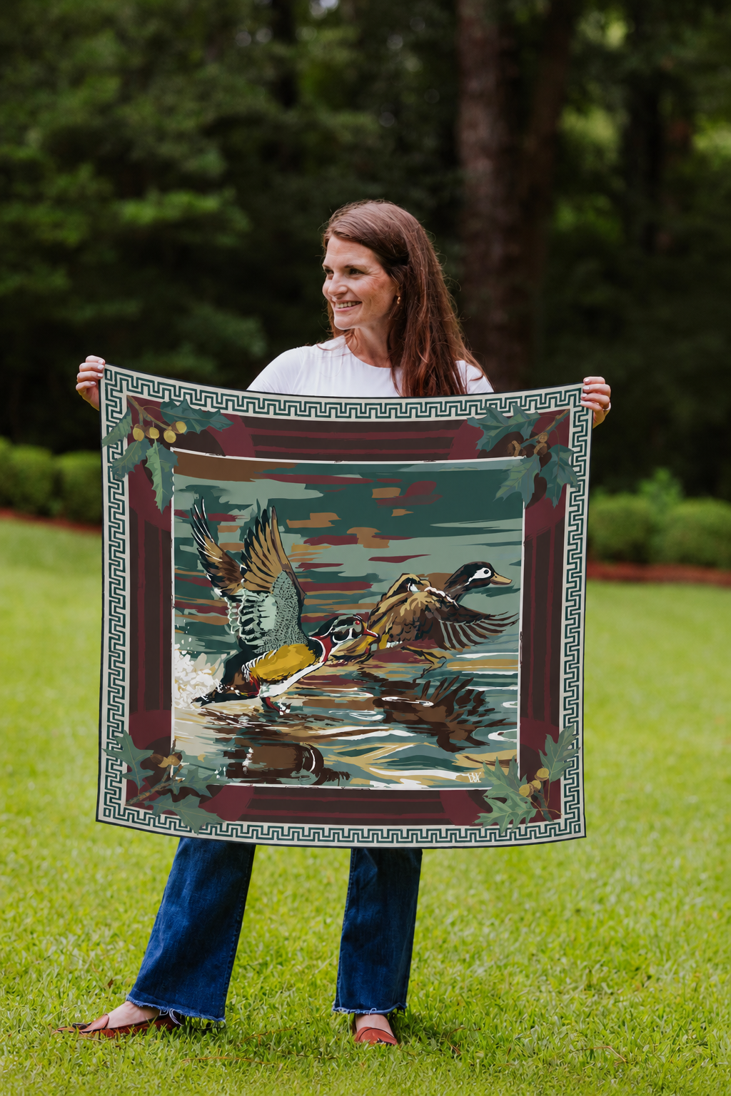 Model holding the Oxblood Dusk Landing wood duck silk scarf