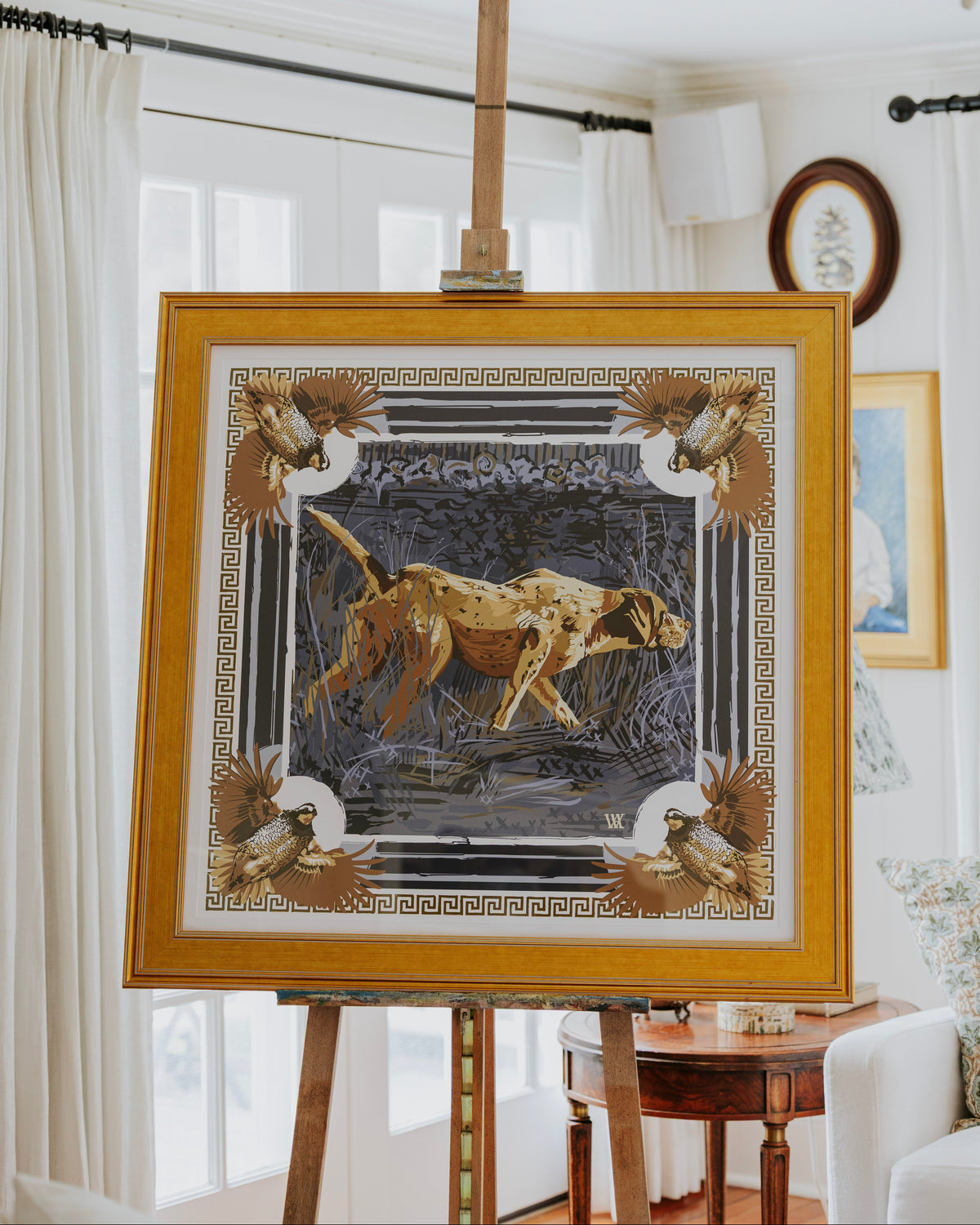 Framed print of pointing dog with greek key border and quail in the corners. 