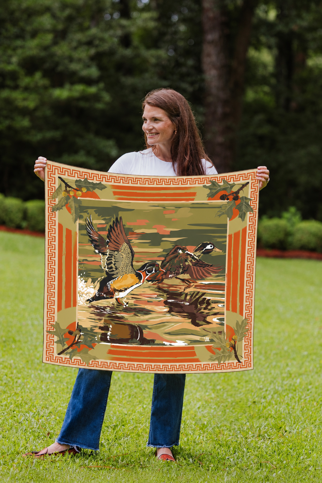 Model holding the Blaze Dusk Landing wood duck silk scarf